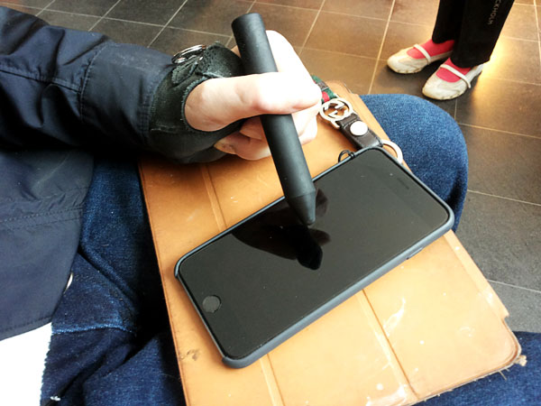 User with holds a thick stylus