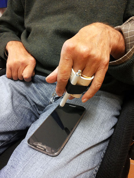 User with telephone and stylus holder